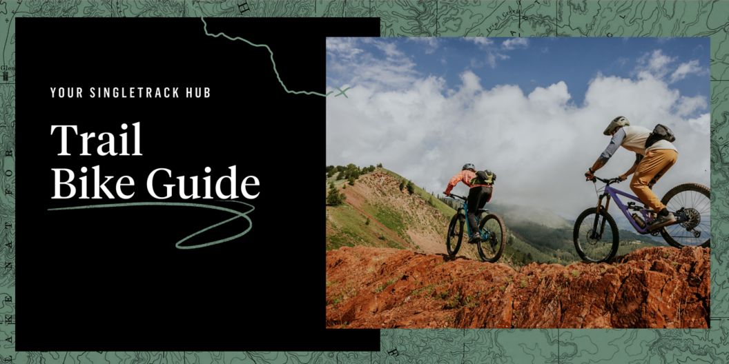 A topographic background with an image of two riders pedaling a ridgeline.  Text overlay reads: Trail Bike Guide. Your singletrack hub. 